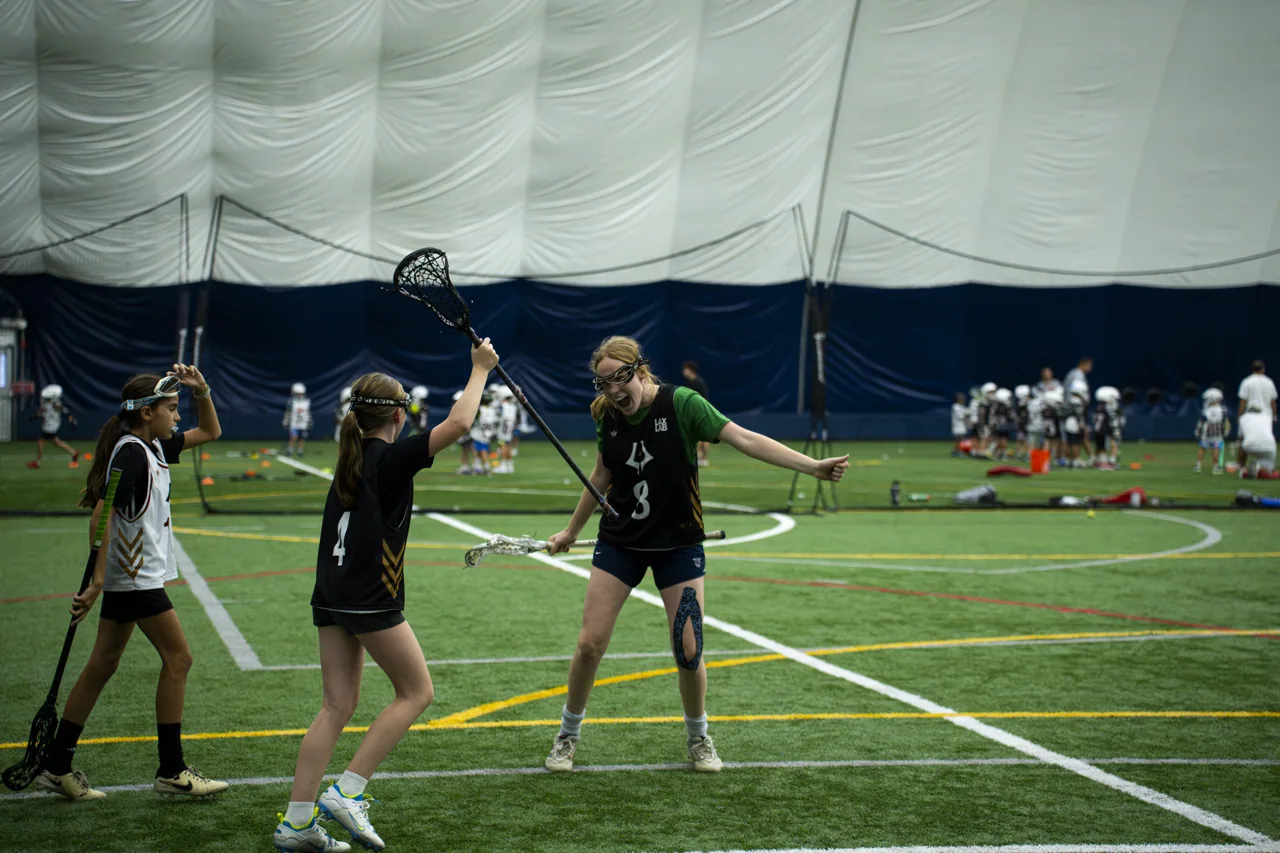 Lacrosse players compete during a training drill