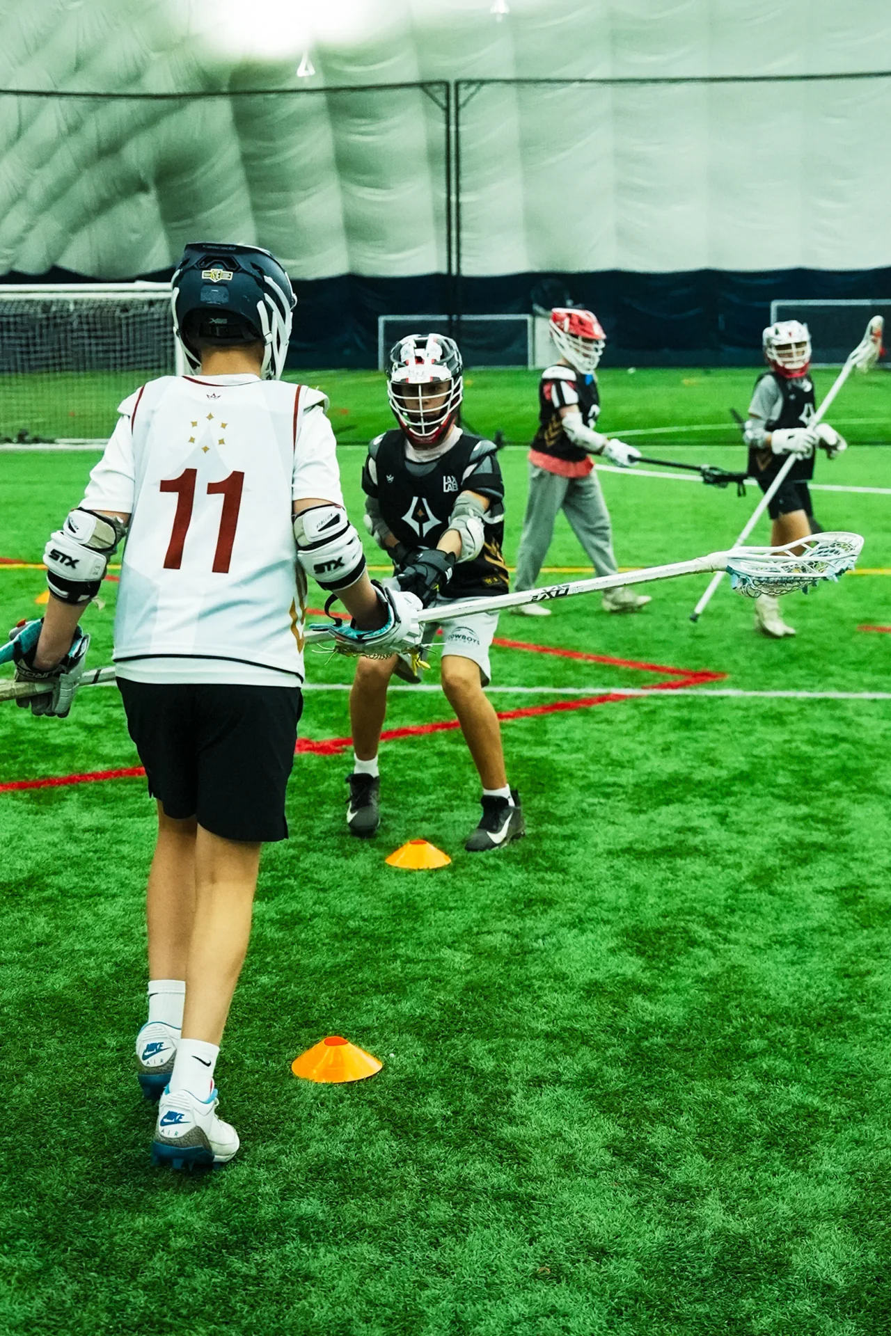 A lacrosse player prepares to pass during practice