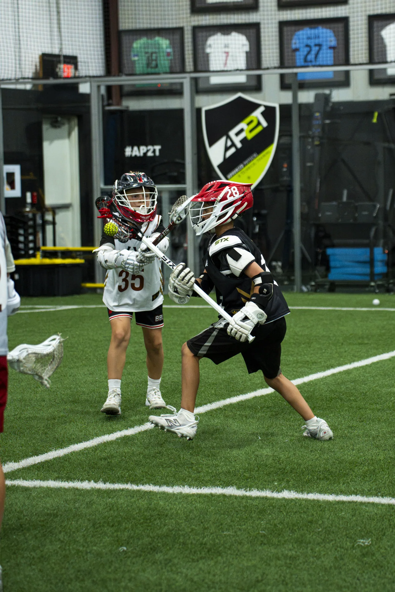 Two athletes work through a competitive lacrosse drill