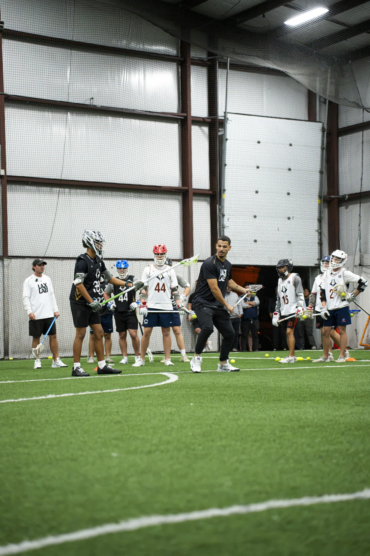 An athlete practices shooting in front of teammates